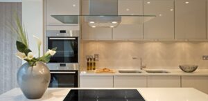 Modern handleless kitchen with an induction hob and integrated ovens