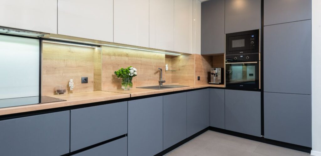 Handleless kitchen units with a wood worktop fitted in a Wigan home