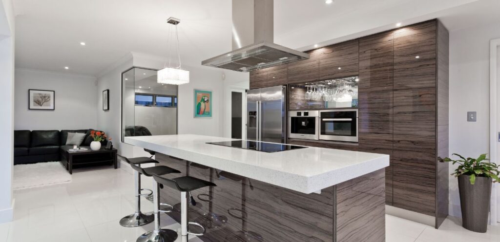 Finished open-plan kitchen with an island fitted by North West Home Renovations