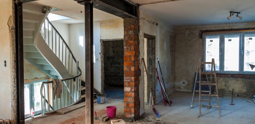 Room stripped back to bare walls during a renovation, ready for new plumbing and electrics